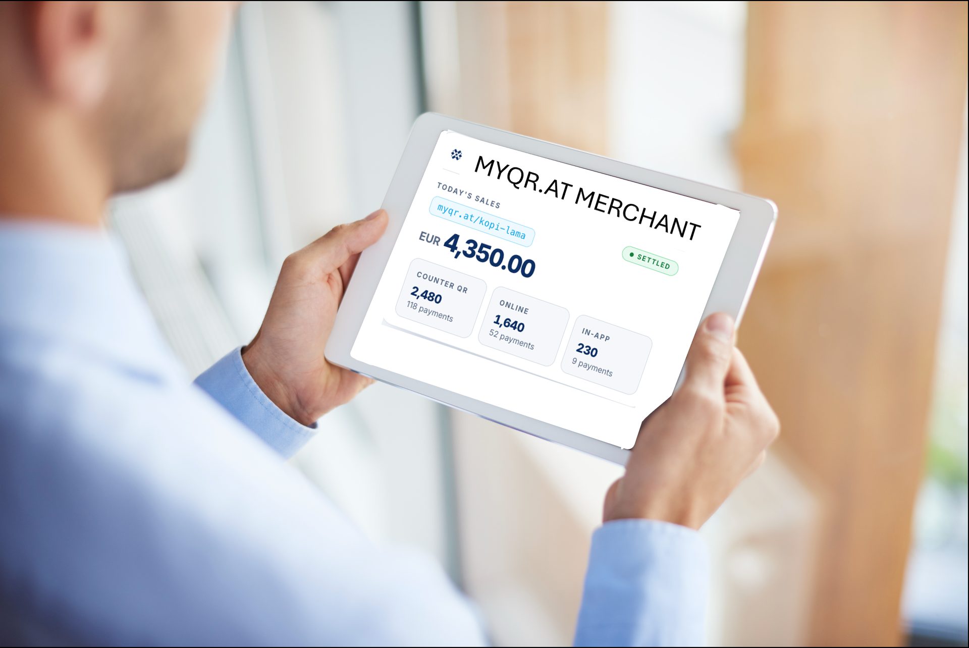 A businessman reviews a MYQR merchant settlement dashboard on a tablet.