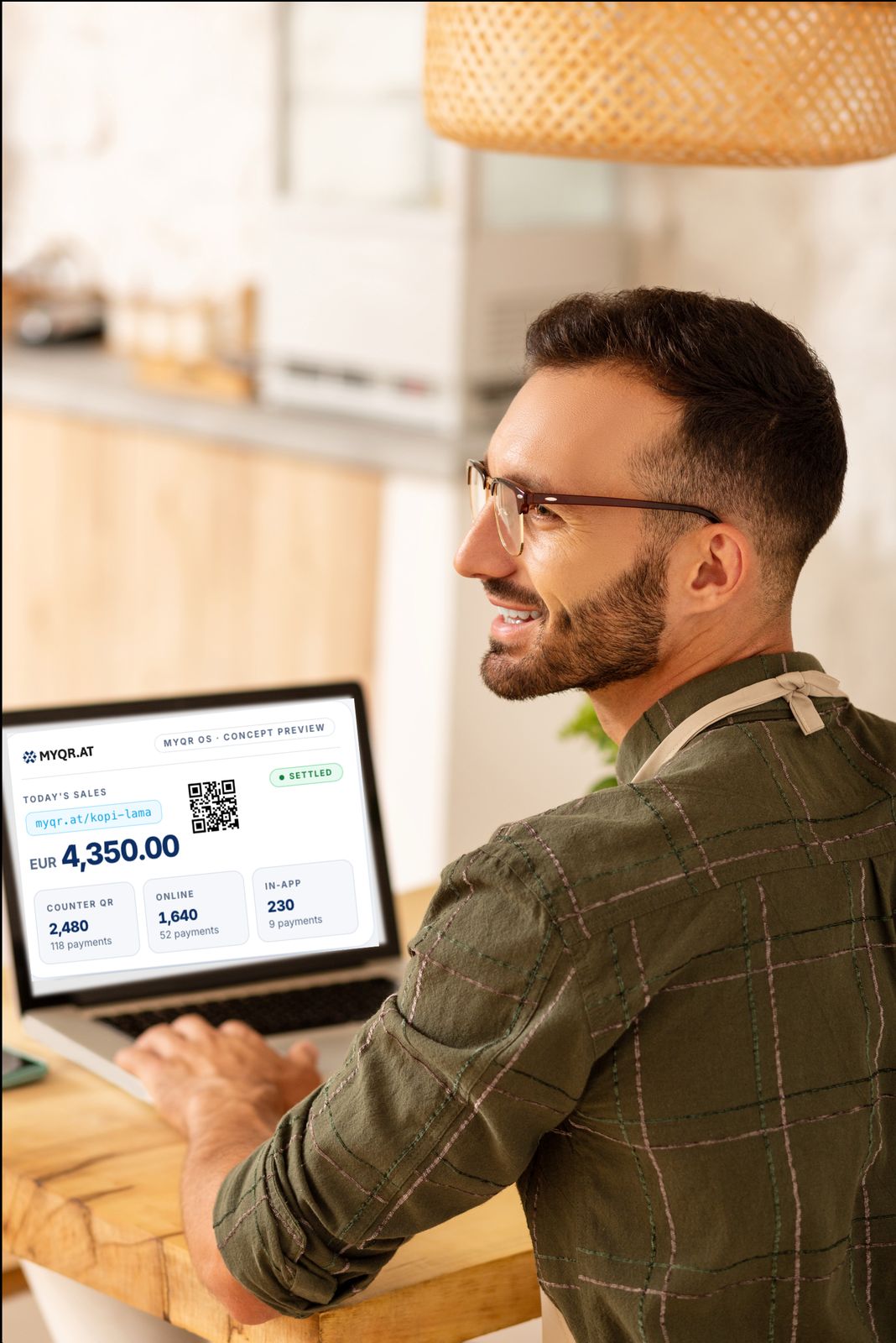 A café owner at his counter reviews a MYQR merchant screen showing today's sales and an acceptance QR code.